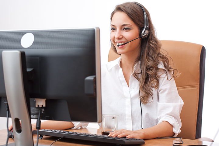 Smiling Woman at Keyboard with Headset
